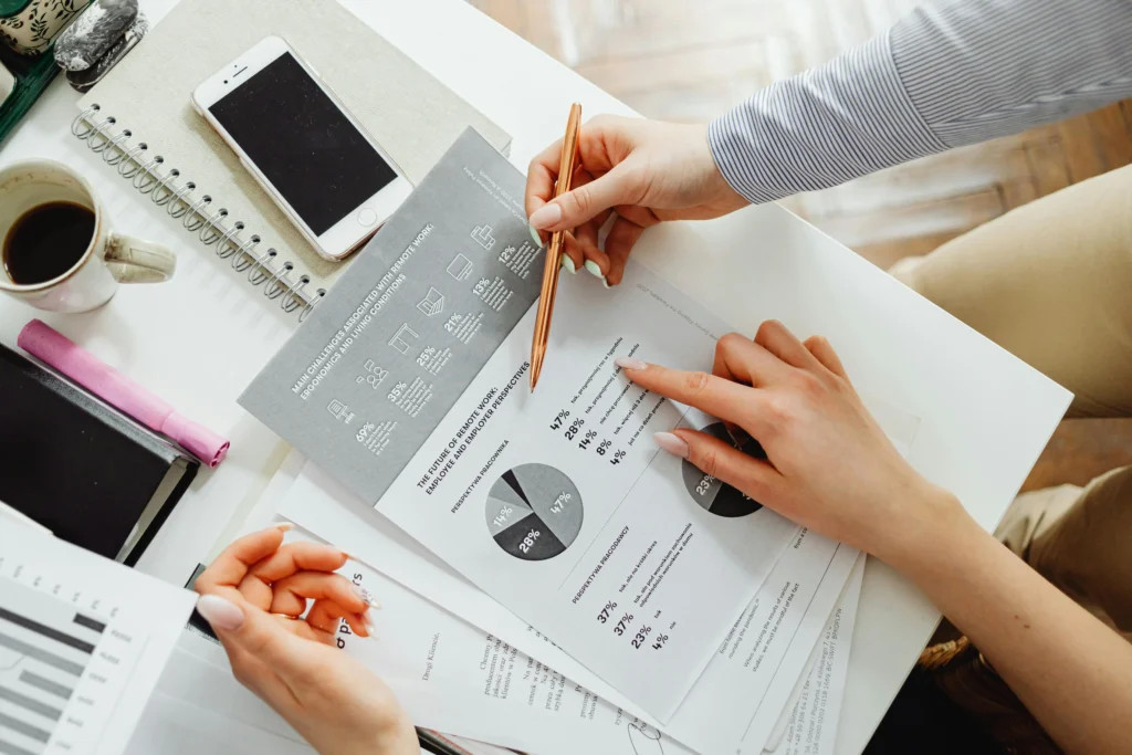 Business professionals analysing performance reports and charts during a digital marketing and website strategy review to improve sales and online growth.