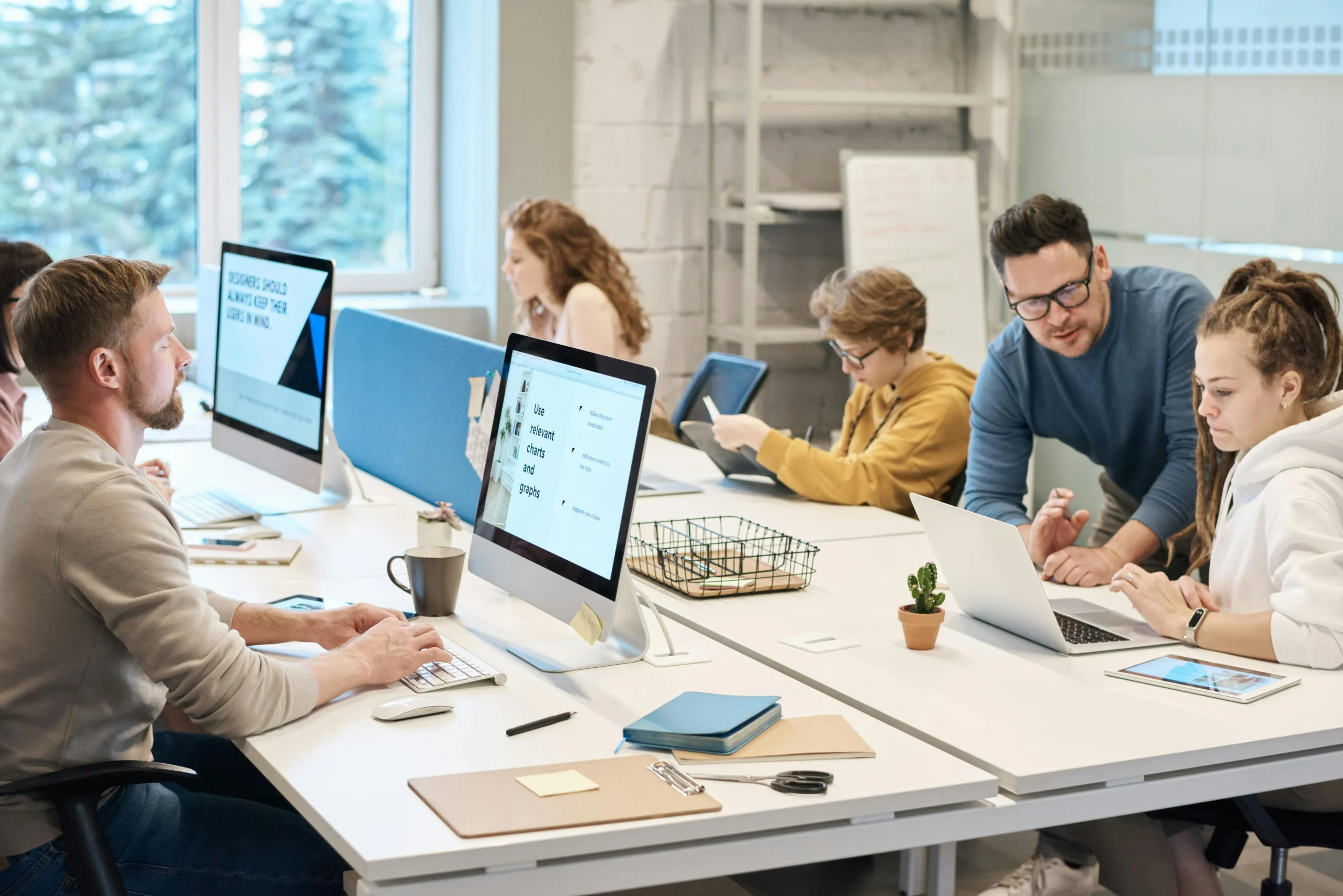 Digital marketing and web design team collaborating in a modern office on website development, SEO and content strategy.