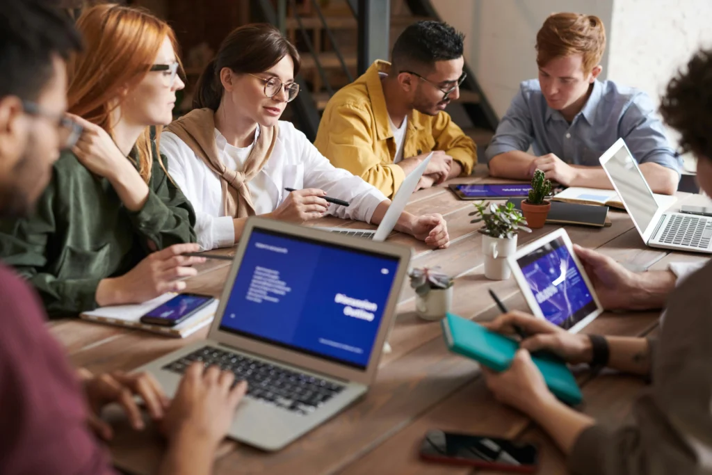 Digital marketing team collaborating on web design, SEO strategy and online business growth during a professional office meeting.
