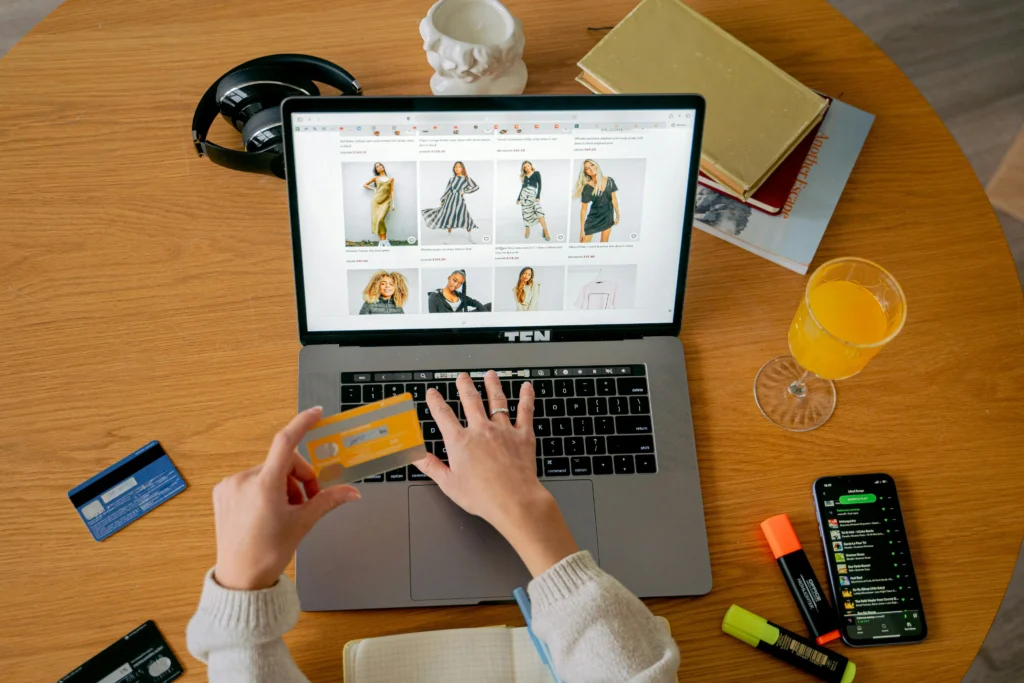 Customer making a secure online shopping payment with a credit card on an e-commerce website using a laptop.