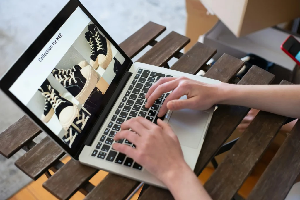 Customer browsing an e-commerce website product catalogue on a laptop, showcasing responsive online shopping website design for retail businesses.